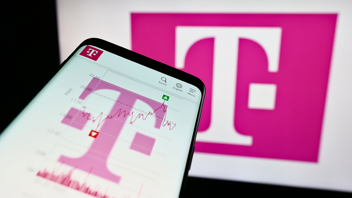 The image shows a smartphone displaying a stock chart with a large, prominent magenta-colored 'T' logo in the background, associated with Deutsche Telekom.