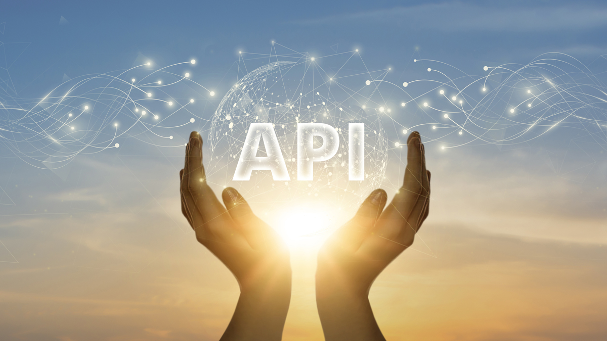 A pair of hands holding a glowing sphere with the word 'API' inside, surrounded by abstract digital connections, symbolizing the integration and connectivity of APIs in technology.