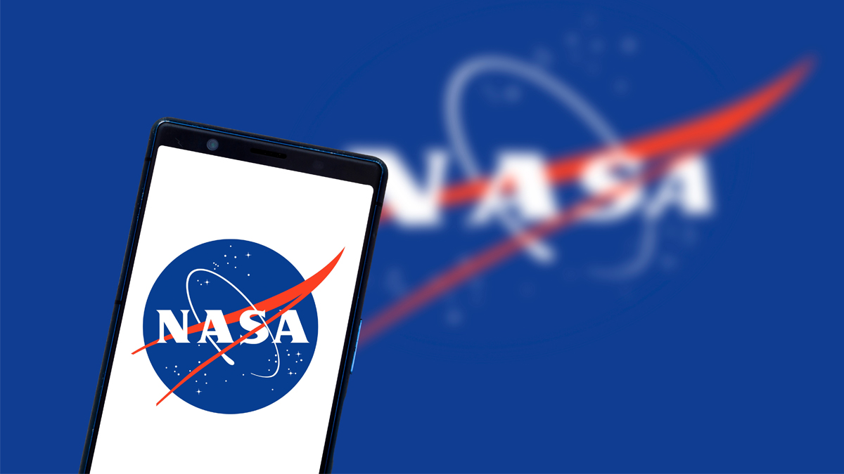 A smartphone displaying the NASA logo with a blurred larger version of the logo in the background.