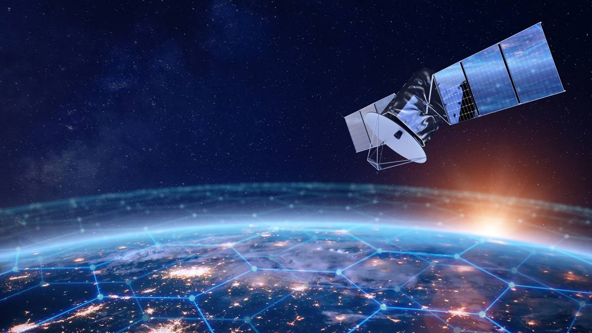 Futuristic satellite with solar panels orbiting Earth at sunrise, with a glowing hexagonal network overlay symbolizing global connectivity and advanced communications technology.